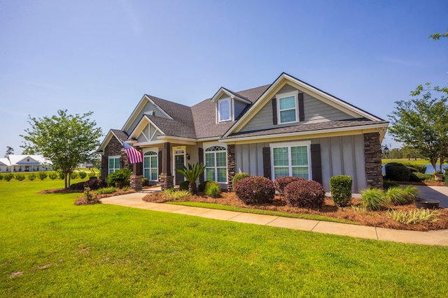 5643 Timberwind Cir, Lake Park, GA 31636 - view of front facade featuring a front lawn, board and batten siding, stone siding, and roof with shingles