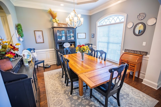5643 Timberwind Cir, Lake Park, GA 31636 - dining space featuring a chandelier, ornamental molding, arched walkways, and dark wood finished floors