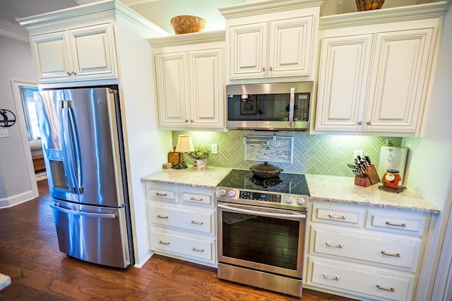 5643 Timberwind Cir, Lake Park, GA 31636 - kitchen with appliances with stainless steel finishes, backsplash, light stone counters, dark wood-style flooring, and baseboards