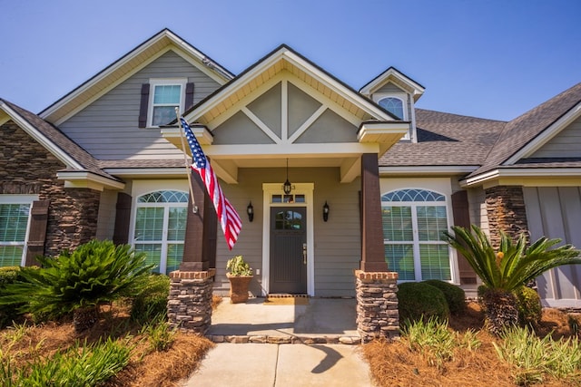5643 Timberwind Cir, Lake Park, GA 31636 - view of exterior entry featuring stone siding, roof with shingles, and covered porch