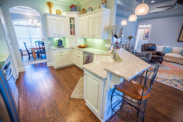 5643 Timberwind Cir, Lake Park, GA 31636 - kitchen with a sink, a peninsula, arched walkways, dishwasher, and crown molding