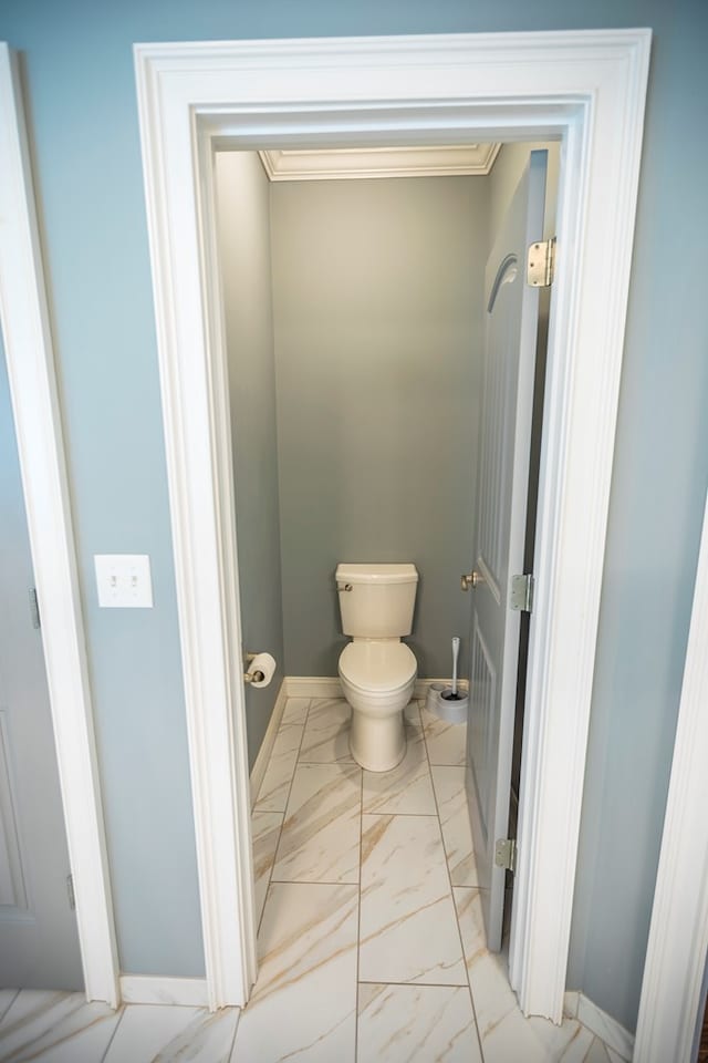 5643 Timberwind Cir, Lake Park, GA 31636 - bathroom featuring marble look tiles, ornamental molding, toilet, and baseboards
