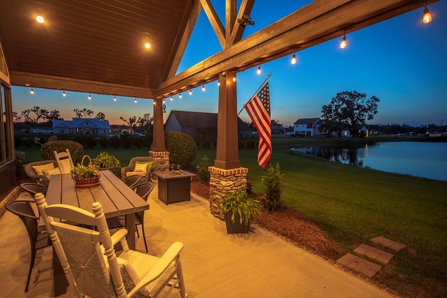 5643 Timberwind Cir, Lake Park, GA 31636 - patio terrace at dusk featuring a lawn, a water view, and a fire pit