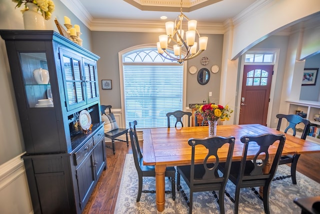 5643 Timberwind Cir, Lake Park, GA 31636 - dining room featuring crown molding, dark wood-type flooring, arched walkways, wainscoting, and a chandelier