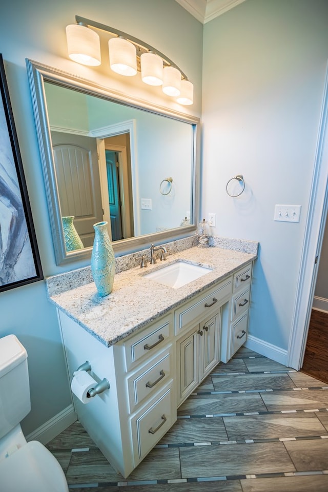 5643 Timberwind Cir, Lake Park, GA 31636 - bathroom with ornamental molding, baseboards, vanity, toilet, and wood finished floors