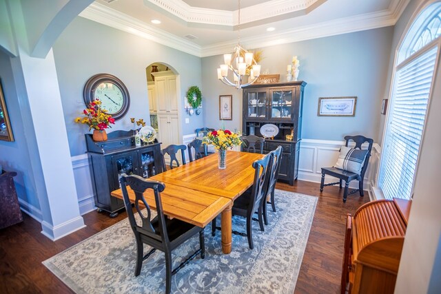 5643 Timberwind Cir, Lake Park, GA 31636 - dining room featuring arched walkways, a chandelier, dark wood-style floors, ornamental molding, and wainscoting