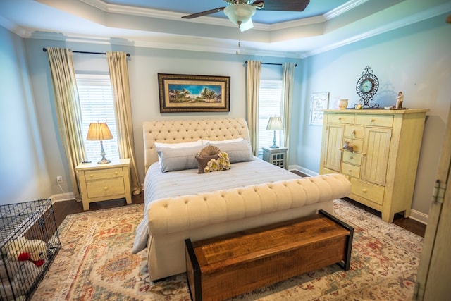 5643 Timberwind Cir, Lake Park, GA 31636 - bedroom with a tray ceiling, crown molding, multiple windows, wood finished floors, and baseboards