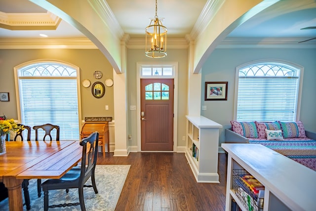 5643 Timberwind Cir, Lake Park, GA 31636 - entrance foyer with arched walkways, a chandelier, dark wood-style floors, crown molding, and baseboards
