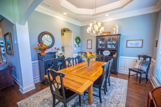 5643 Timberwind Cir, Lake Park, GA 31636 - dining area with arched walkways, a chandelier, a raised ceiling, dark wood-style floors, and crown molding