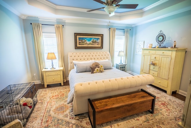 5643 Timberwind Cir, Lake Park, GA 31636 - bedroom with crown molding, a raised ceiling, wood finished floors, multiple windows, and baseboards