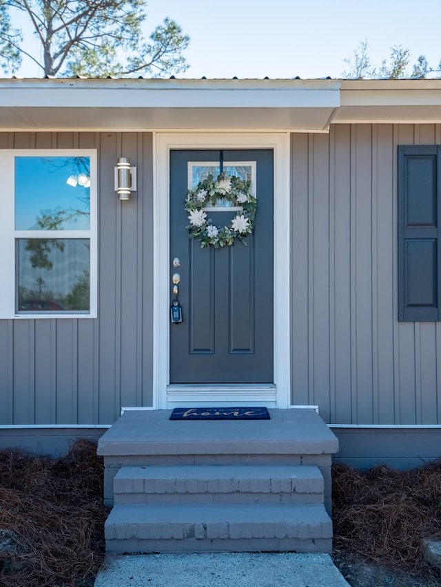 property entrance featuring board and batten siding