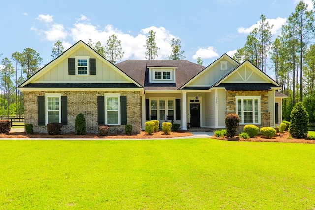 5555 Boyette Rd, Hahira, GA 31636 - craftsman-style home featuring board and batten siding, a front yard, brick siding, and a shingled roof