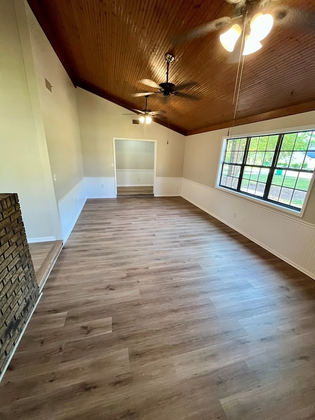 spare room with lofted ceiling, ceiling fan, wooden ceiling, and wood finished floors
