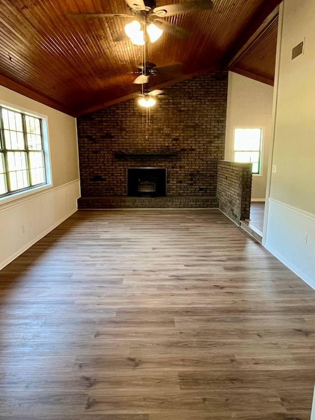 unfurnished living room with wooden ceiling, a ceiling fan, and vaulted ceiling with beams