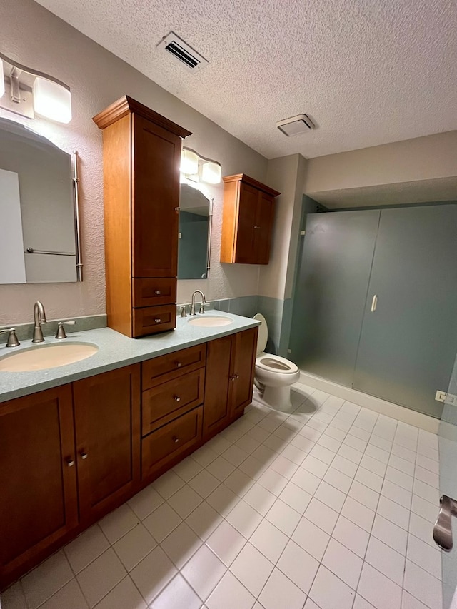bathroom featuring a sink, a textured ceiling, and visible vents