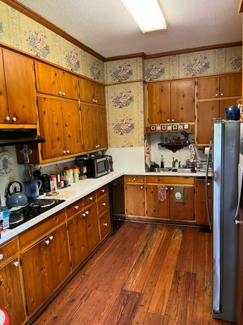 kitchen with sink, stainless steel appliances, crown molding, dark wood-type flooring, and a textured ceiling