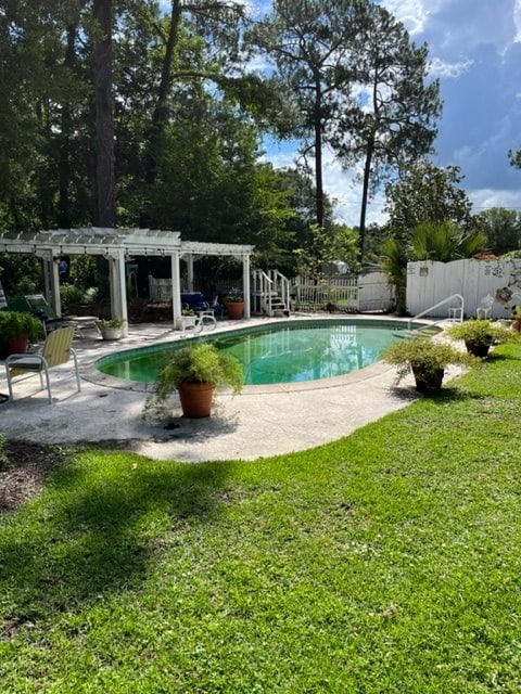 view of swimming pool featuring a pergola, a patio area, and a lawn