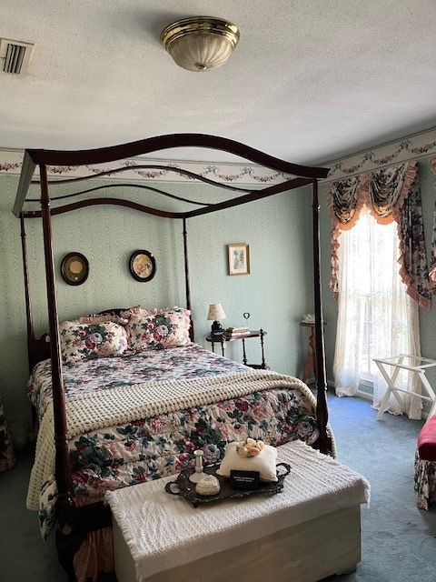 bedroom featuring carpet floors and a textured ceiling