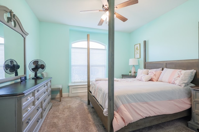 bedroom featuring baseboards, a ceiling fan, and light colored carpet