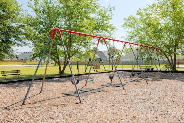 community jungle gym featuring a yard