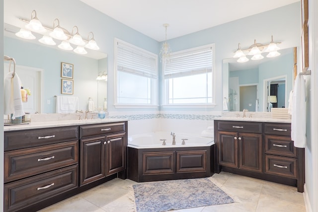 bathroom with two vanities, a sink, a bath, and tile patterned floors