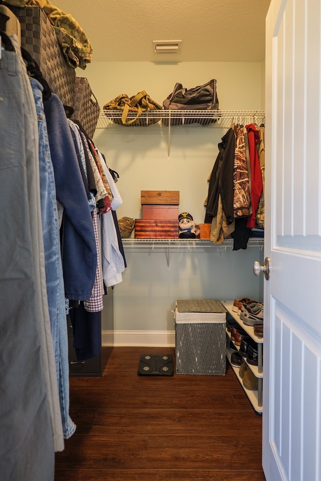 walk in closet with visible vents and wood finished floors