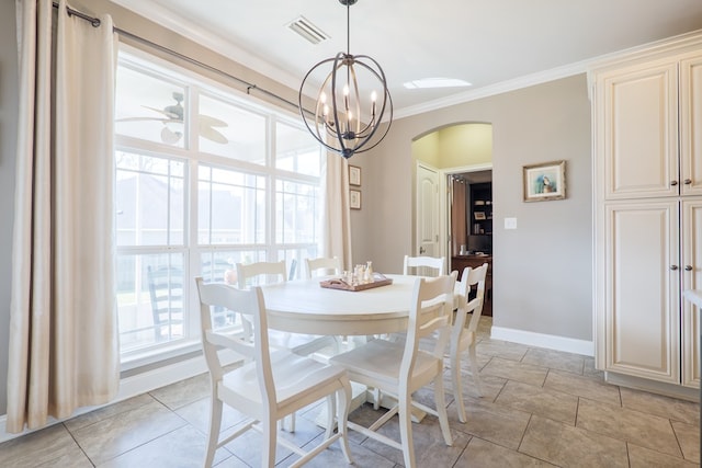 dining space with baseboards, visible vents, arched walkways, ornamental molding, and ceiling fan with notable chandelier