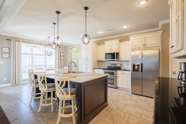 kitchen with arched walkways, a sink, appliances with stainless steel finishes, ornamental molding, and tasteful backsplash