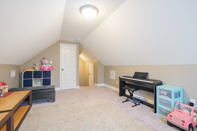 interior space with vaulted ceiling, visible vents, and baseboards