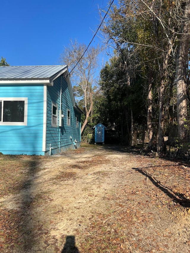 view of side of property featuring a storage unit