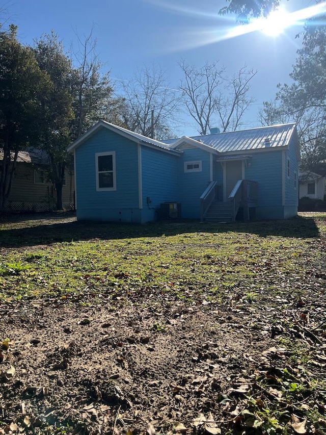 119 E Merrill St, Thomasville, GA 31792 - rear view of property with metal roof, a yard, and central AC