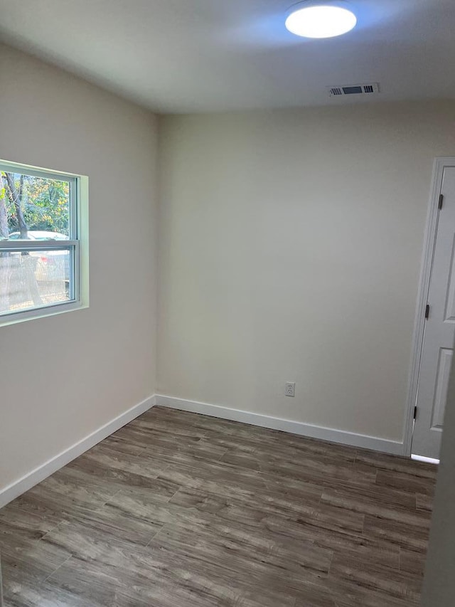 spare room with dark hardwood / wood-style floors