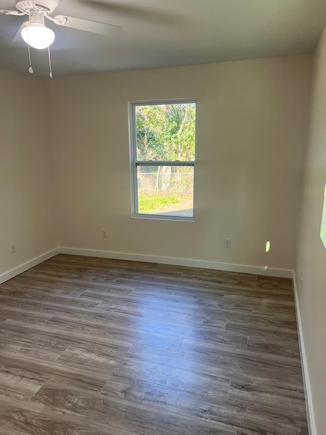 unfurnished room with hardwood / wood-style floors and ceiling fan