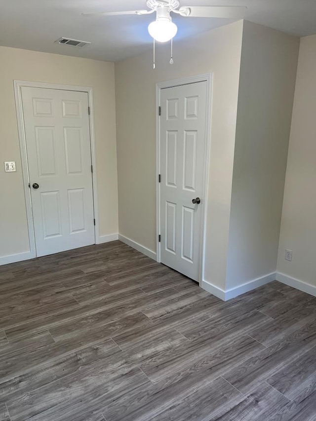 empty room with hardwood / wood-style floors and ceiling fan