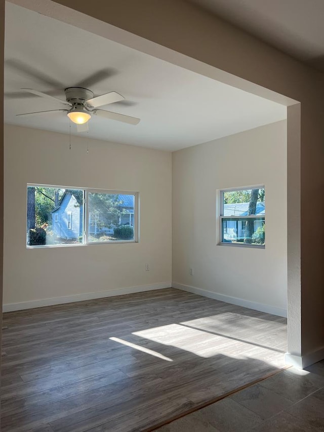 unfurnished room with plenty of natural light, hardwood / wood-style floors, and ceiling fan