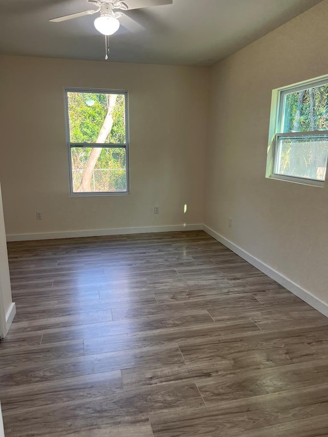 spare room featuring dark wood-type flooring and ceiling fan