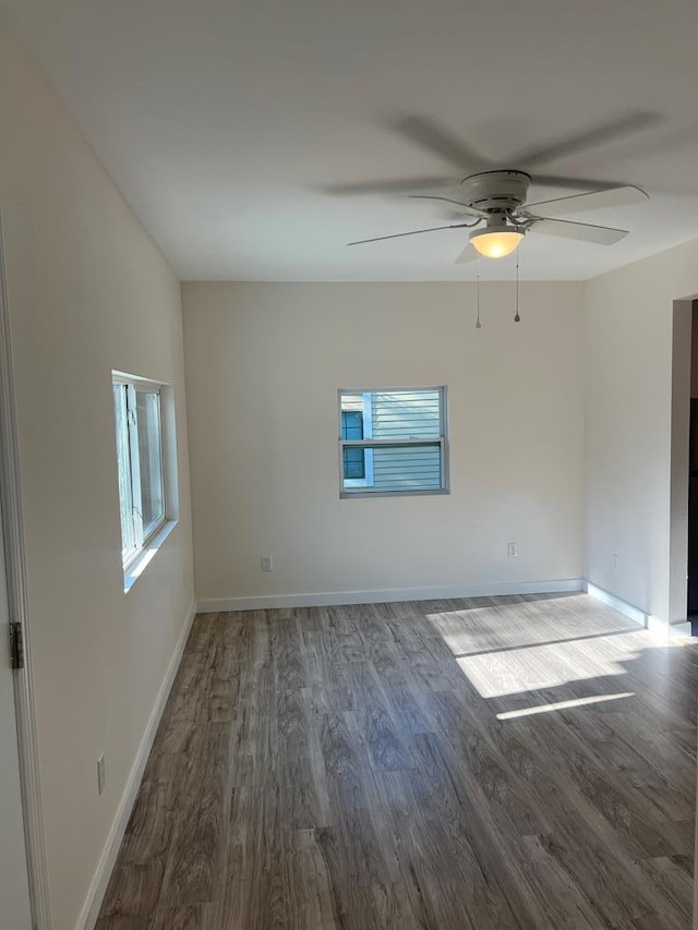 spare room featuring hardwood / wood-style floors, a wealth of natural light, and ceiling fan