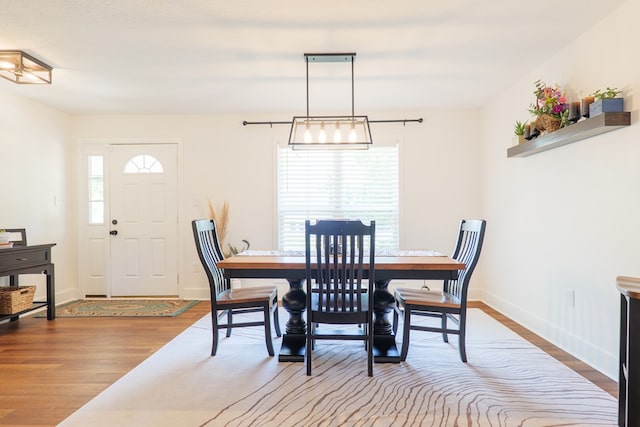 dining space with wood finished floors and baseboards