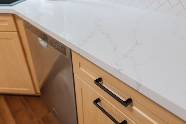 details featuring light brown cabinetry and light countertops