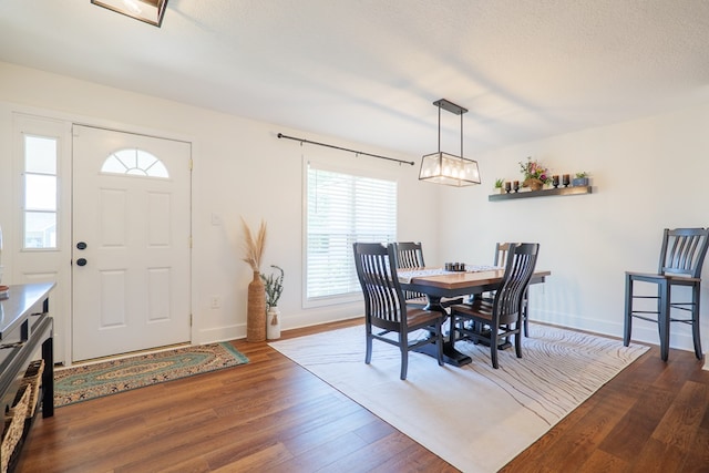 dining room with wood finished floors and baseboards