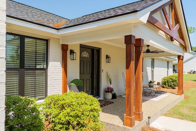 doorway to property with brick siding and a porch