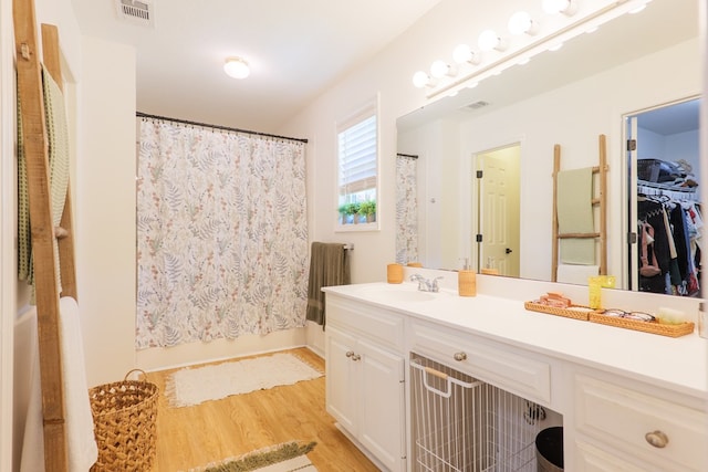 bathroom featuring wood finished floors, visible vents, vanity, and a shower with shower curtain