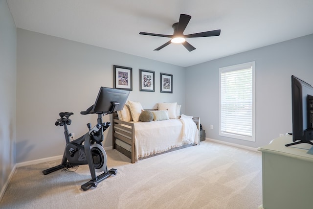 carpeted bedroom with baseboards and a ceiling fan