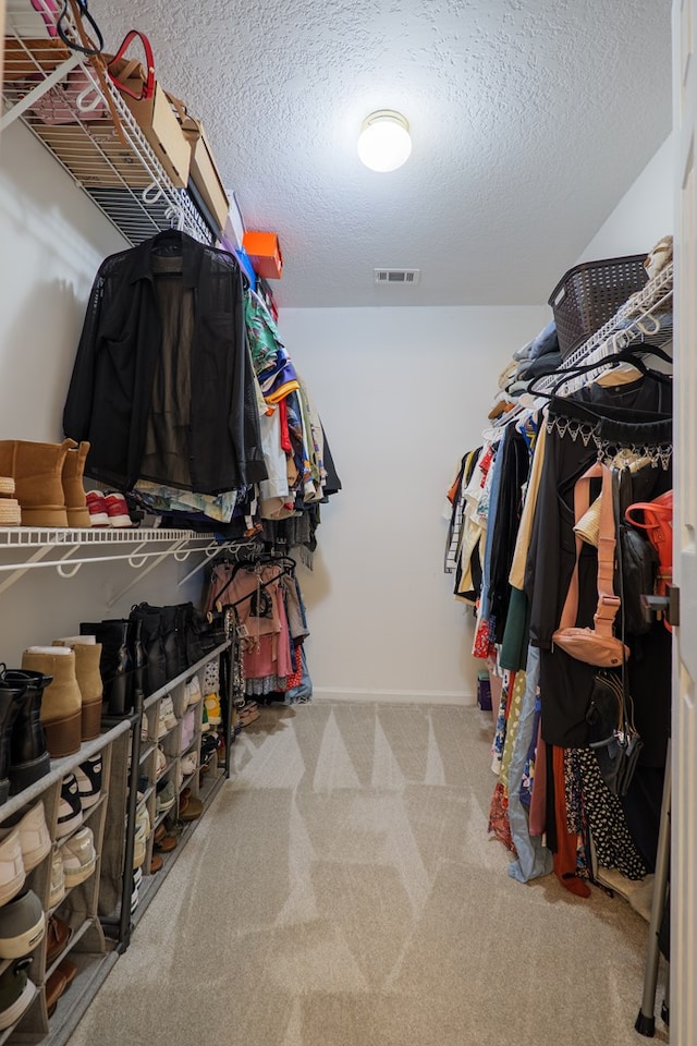 walk in closet with visible vents and carpet flooring