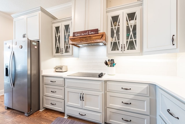 3041 Houser Way, Hahira, GA 31632 - kitchen with light wood-style flooring, light countertops, stainless steel refrigerator with ice dispenser, black electric cooktop, and tasteful backsplash