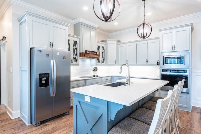 3041 Houser Way, Hahira, GA 31632 - kitchen featuring light wood finished floors, appliances with stainless steel finishes, light countertops, and a sink