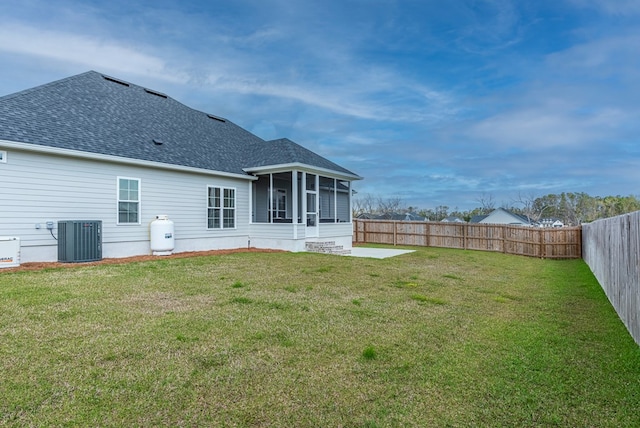 3041 Houser Way, Hahira, GA 31632 - back of house featuring central air condition unit, a lawn, roof with shingles, and a sunroom