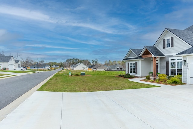 3041 Houser Way, Hahira, GA 31632 - exterior space with driveway, roof with shingles, a front lawn, a garage, and a residential view