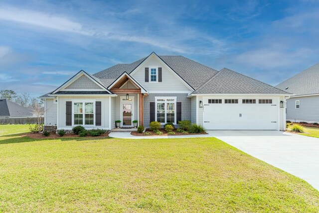 3041 Houser Way, Hahira, GA 31632 - craftsman-style house with an attached garage, concrete driveway, a front lawn, and a shingled roof