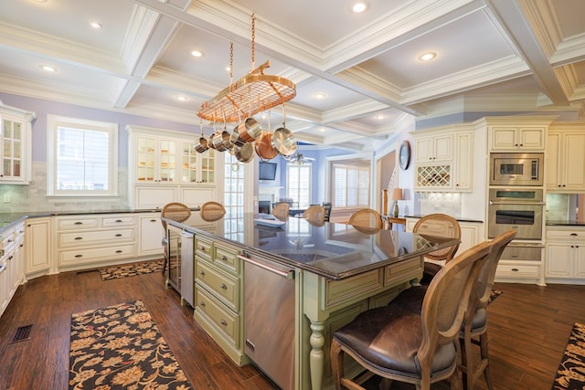 kitchen featuring a notable chandelier, cream cabinetry, stainless steel appliances, and coffered ceiling